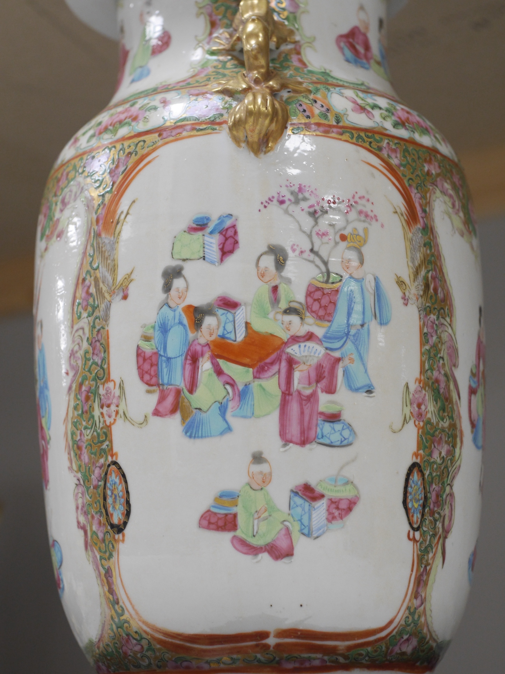 A Chinese famille rose vase and cover, late 19th century, together with a good carved hongmu ‘bats and shou’ stand, vase 36cm. Condition - crack to rim